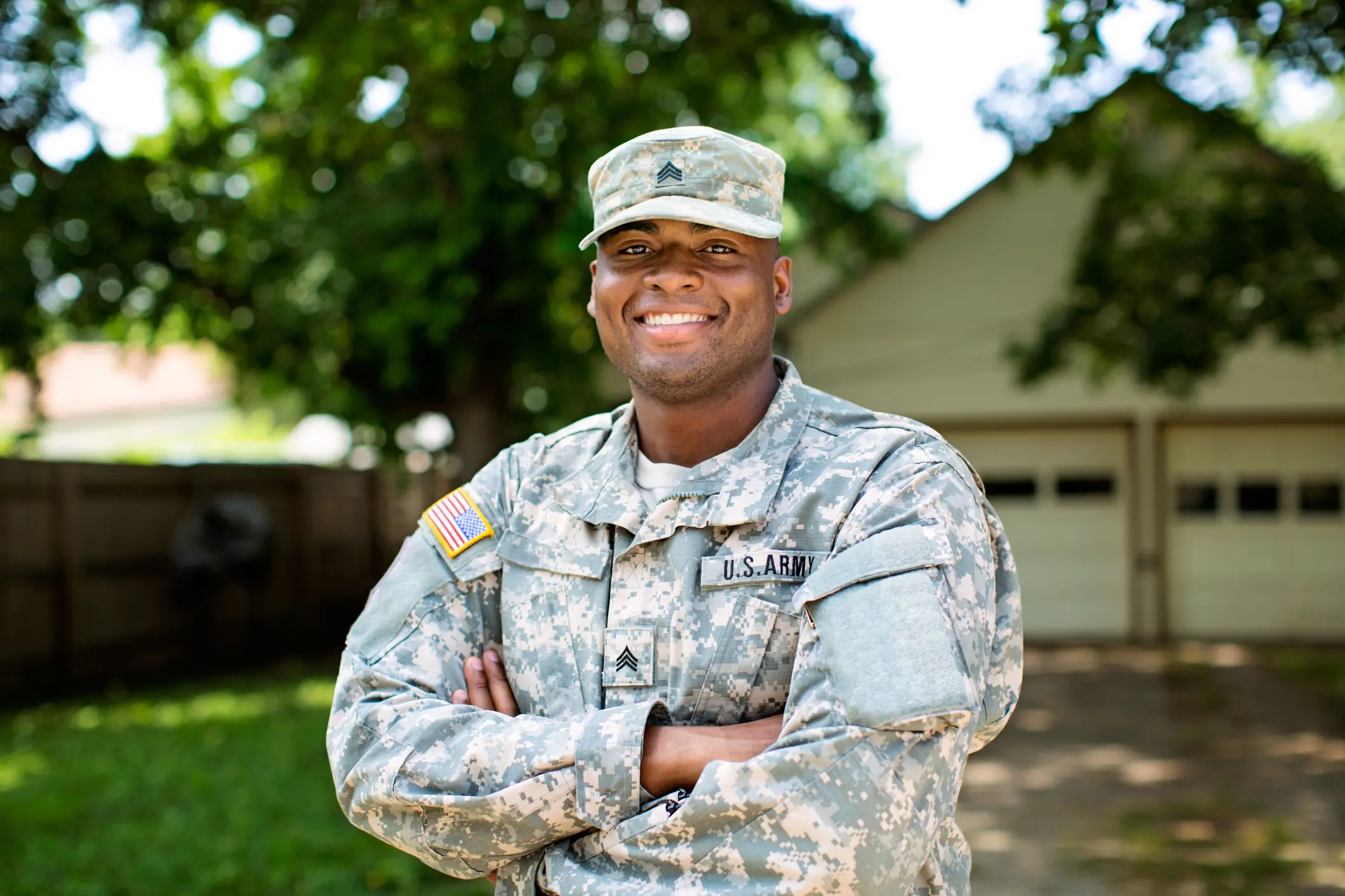 Smiling soldier in camouflage uniform outdoors