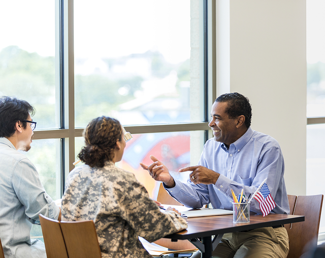 People conversing in bright room