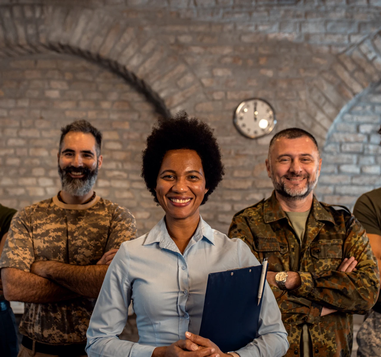 Diverse group smiling in casual and military attire